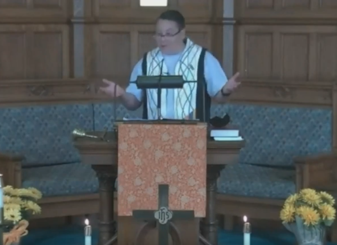 Reverend Jenn Hind-Urquhart preaching at the pulpit.